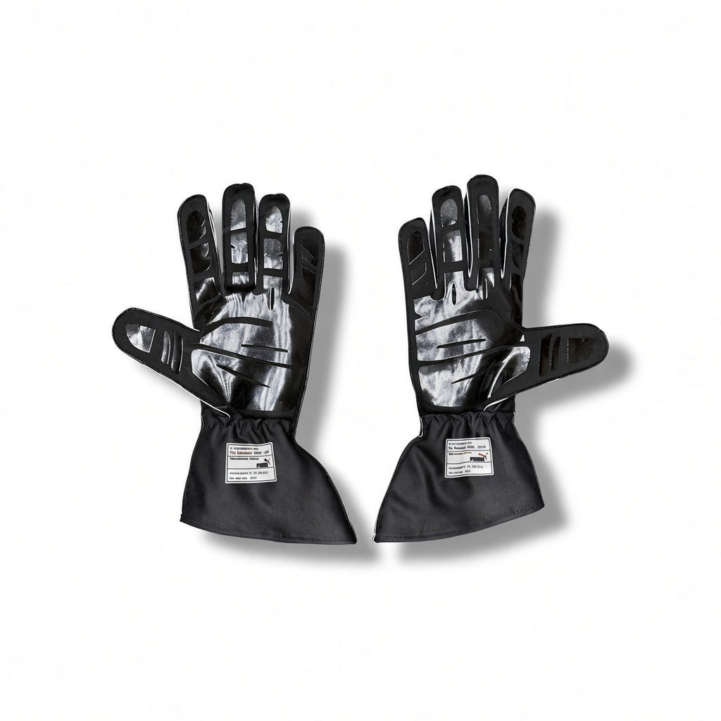Pair of black racing gloves with brown accents on a white background
