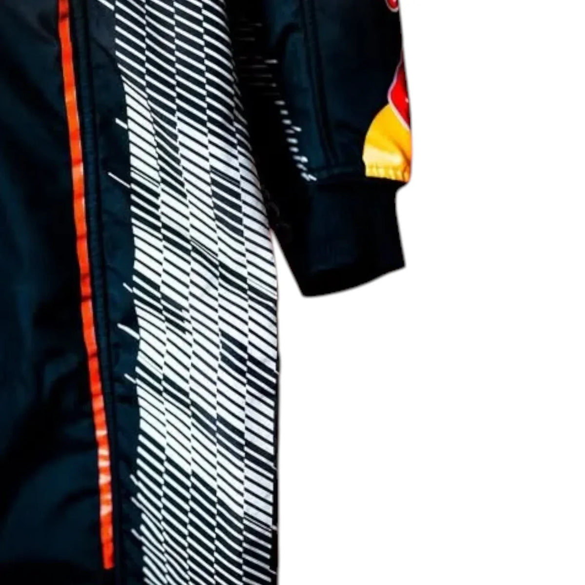 Close-up of a dark navy or black racing suit with a bold diagonal striped pattern in white and black, an orange side stripe, and a Red Bull logo patch on the sleeve.
