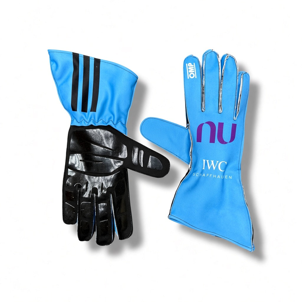 2026 Mercedes AMG Petronas F1 Racing Gloves shown against a white background. One glove is oriented palm-up, displaying three black stripes on the blue cuff and a black textured palm.