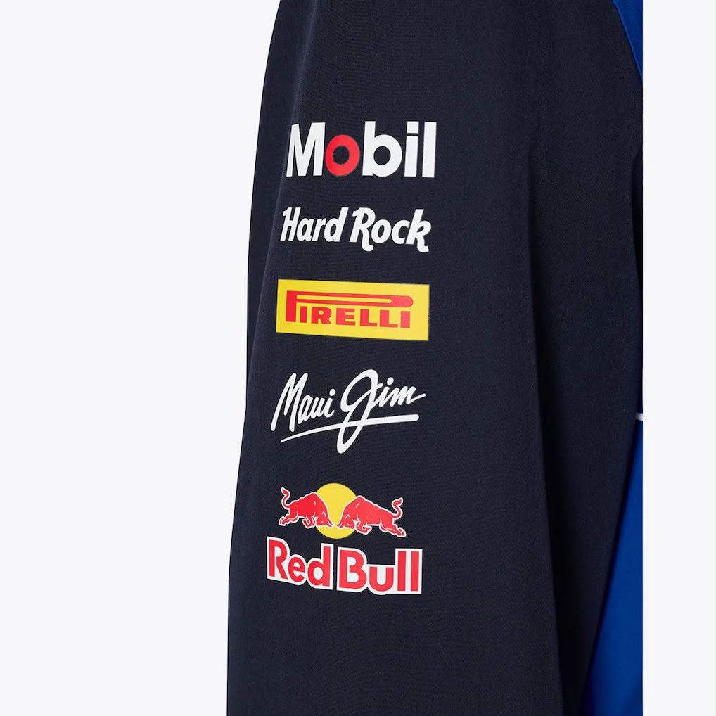 Close-up of a dark blue fabric with various logos including Mobil, Hard Rock, Pirelli, Maui Jim, and Red Bull.