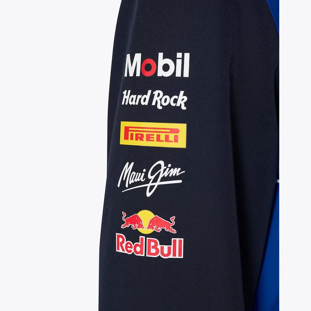 Close-up of a dark blue fabric with various logos including Mobil, Hard Rock, Pirelli, Maui Jim, and Red Bull.
