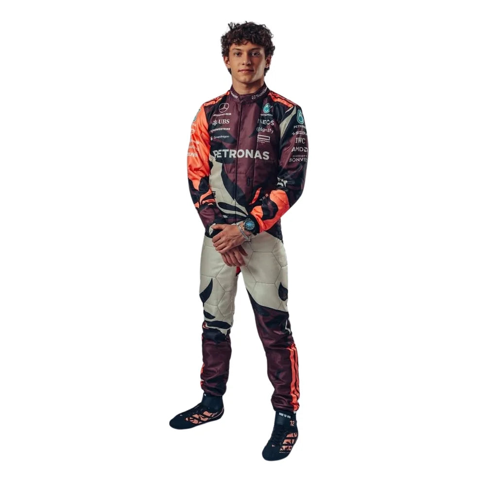 Andrea Kimi Antonelli in Mercedes 2025 Miami GP F1 Racing Suit with prominent Mercedes and Petronas branding, featuring a dark patterned design with orange, beige, and black sections, paired with dark racing shoes, against a plain white background.