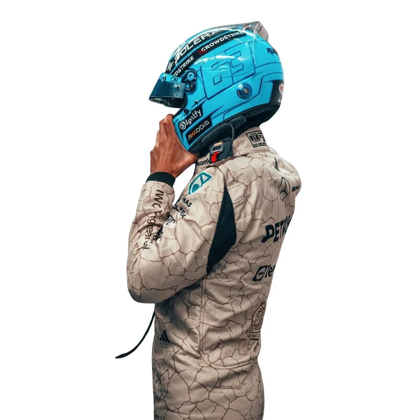Andrea Kimi Antonelli wearing a blue racing helmet and matching suit on a white background