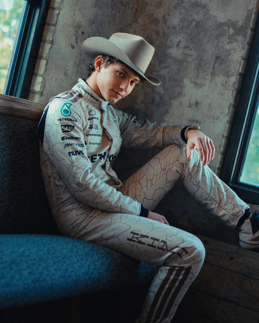 Andrea Kimi Antonelli in Mercedes 2025 USA Austin GP F1 Racing Suit and cowboy hat sitting inside a vehicle.