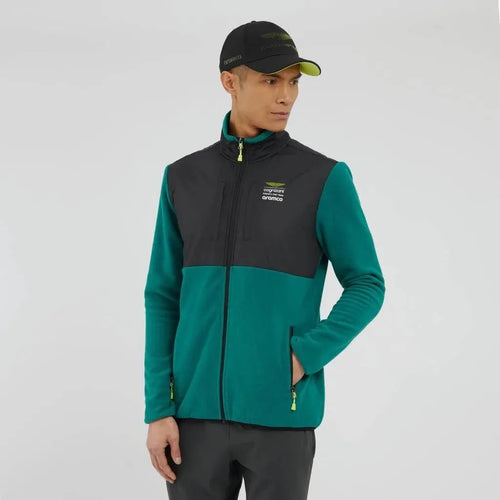 Man wearing a green and black jacket with a visible brand logo on a white background