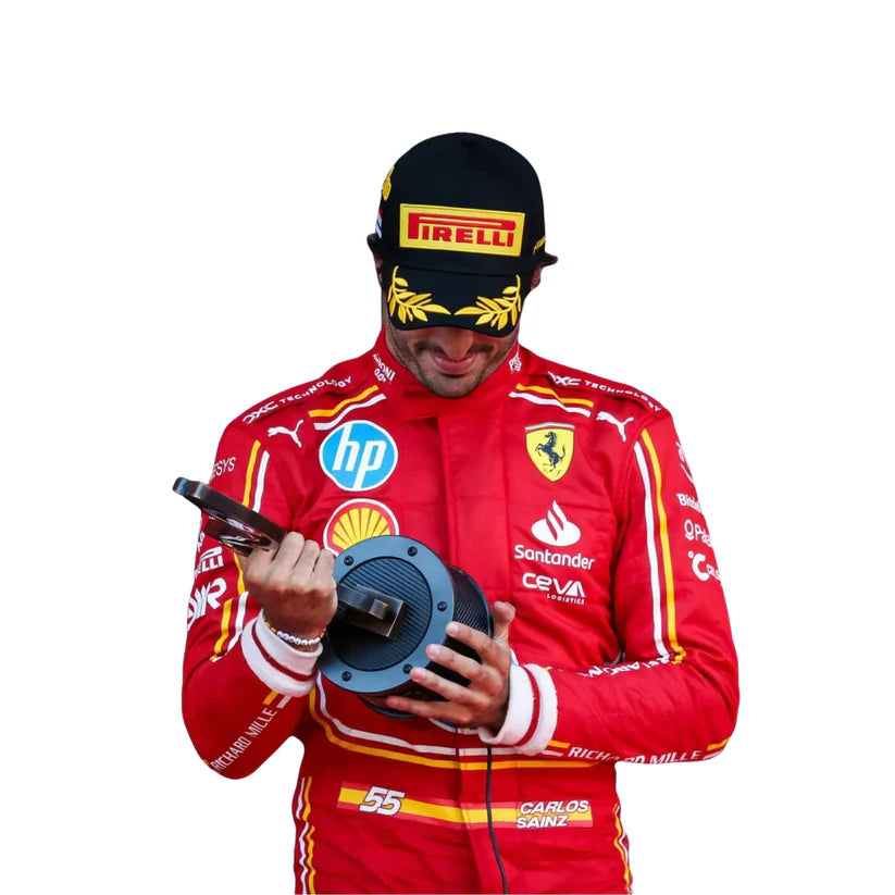 Carlos Sainz in Ferrari 2024 Hp Monaco GP F1 Racing Suit with various sponsor logos, holding a wheel.