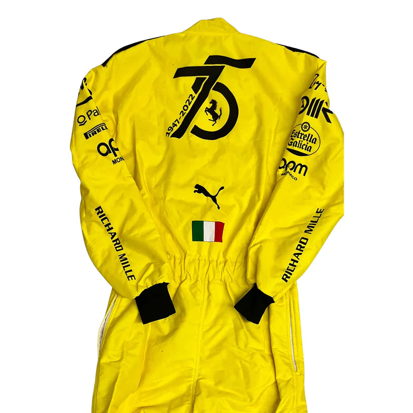 Yellow Ferrari racing suit with various logos on a white background
