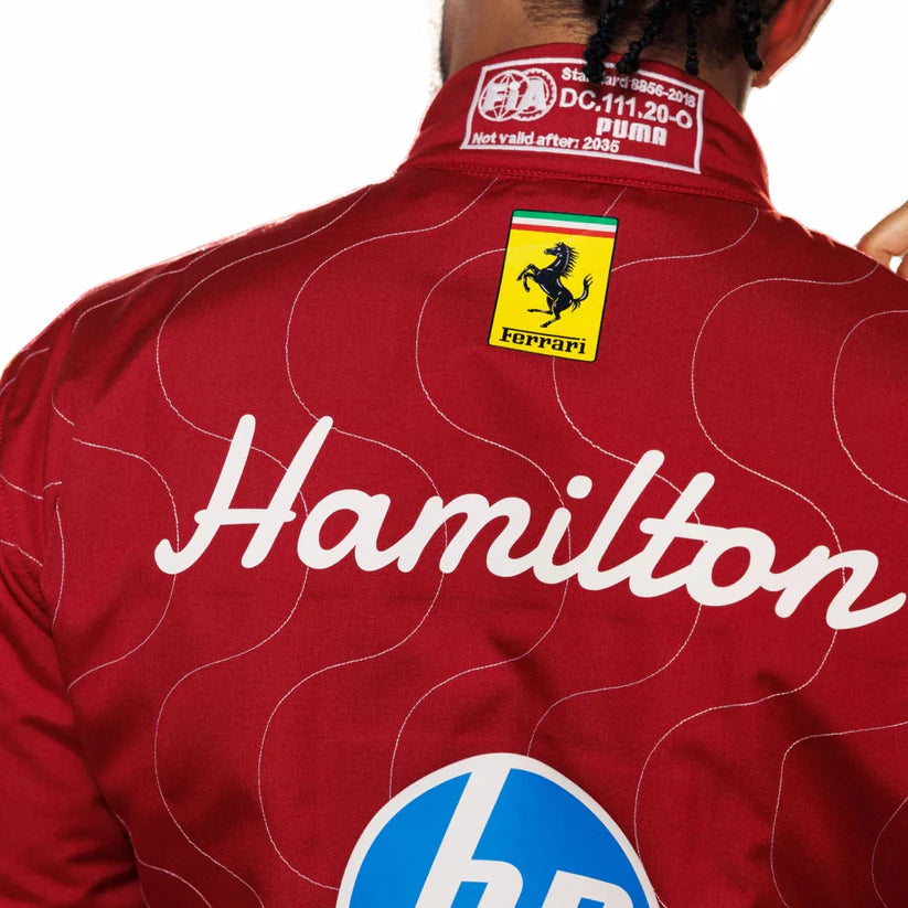 2025 Ferrari racing suit with 'Hamilton' branding and Ferrari logo on a white background