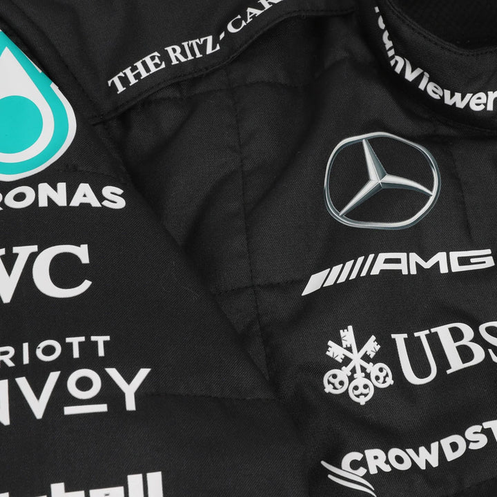 Black Formula 1 Suit with various logos including Mercedes-Benz, UBS, and others on a close-up view.