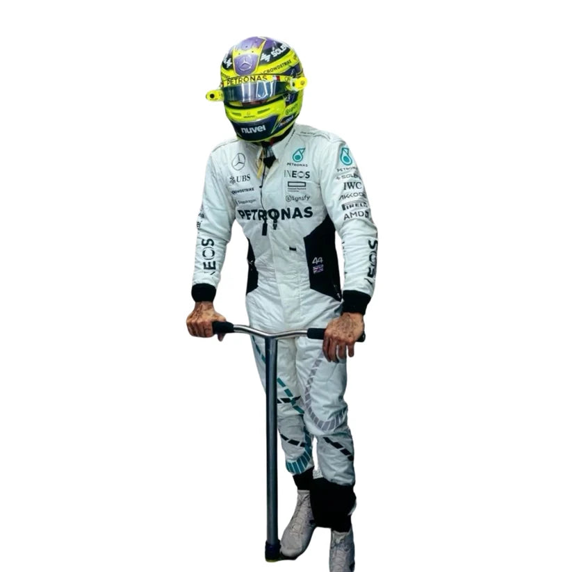 A full-body cutout of Mercedes Formula 1 driver Lewis Hamilton wearing his white racing suit with Petronas and sponsor logos, a yellow and blue helmet, and standing on a kick scooter against a plain white background.
