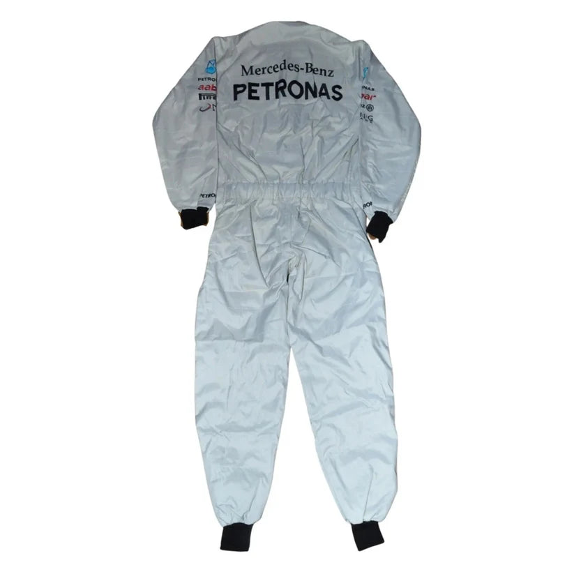 A light silver-gray Mercedes-Benz Petronas racing one-piece suit shown from the back, featuring black cuffs and ankle ties, with sponsor logos printed on the back.