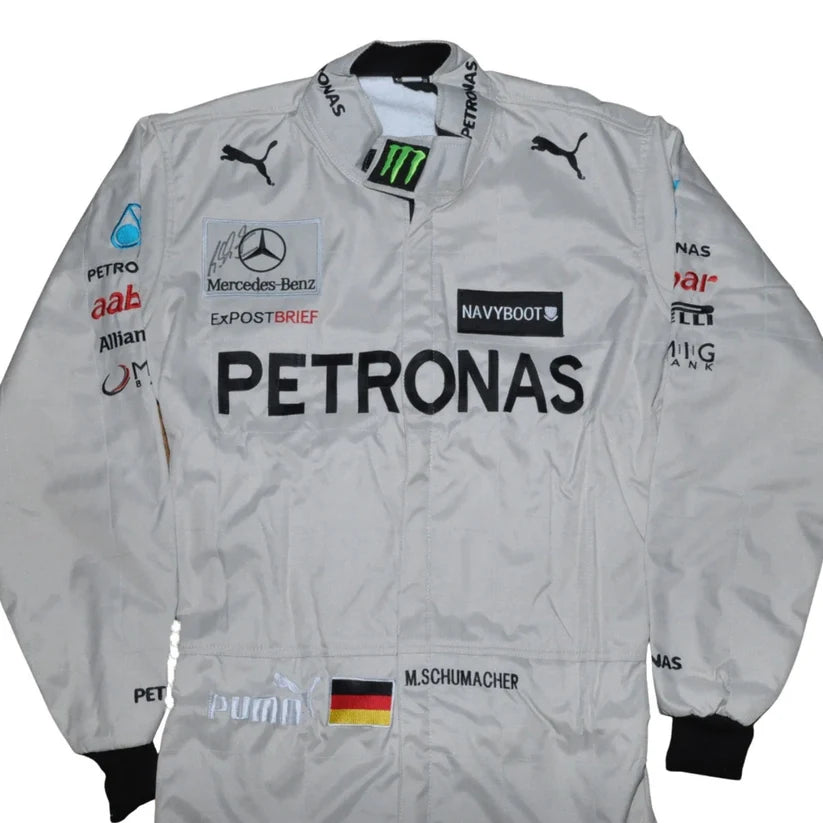 A white Mercedes Petronas racing jacket with black and multi-color sponsor logos, featuring Puma and Mercedes-Benz branding.