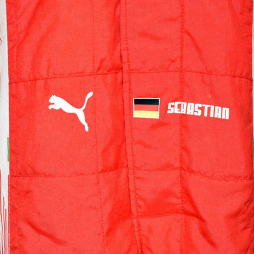 Close-up of a red quilted Puma jacket or vest with a white Puma logo, a small German flag patch, and the name 'SEBASTIAN' printed in white.