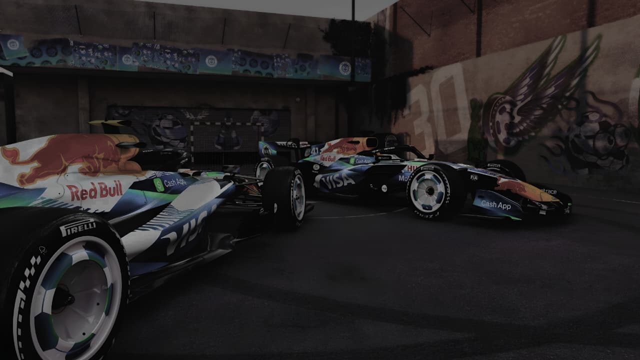 Two Formula 1 cars on a track with a dark background