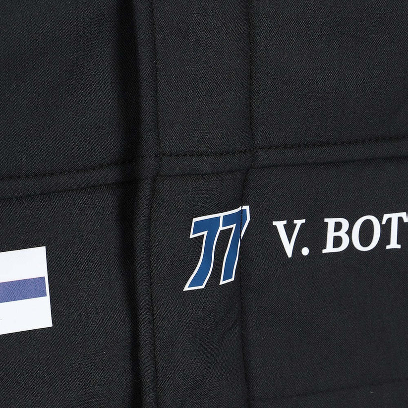 Close-up of a black jacket with logos and text on the chest area.
