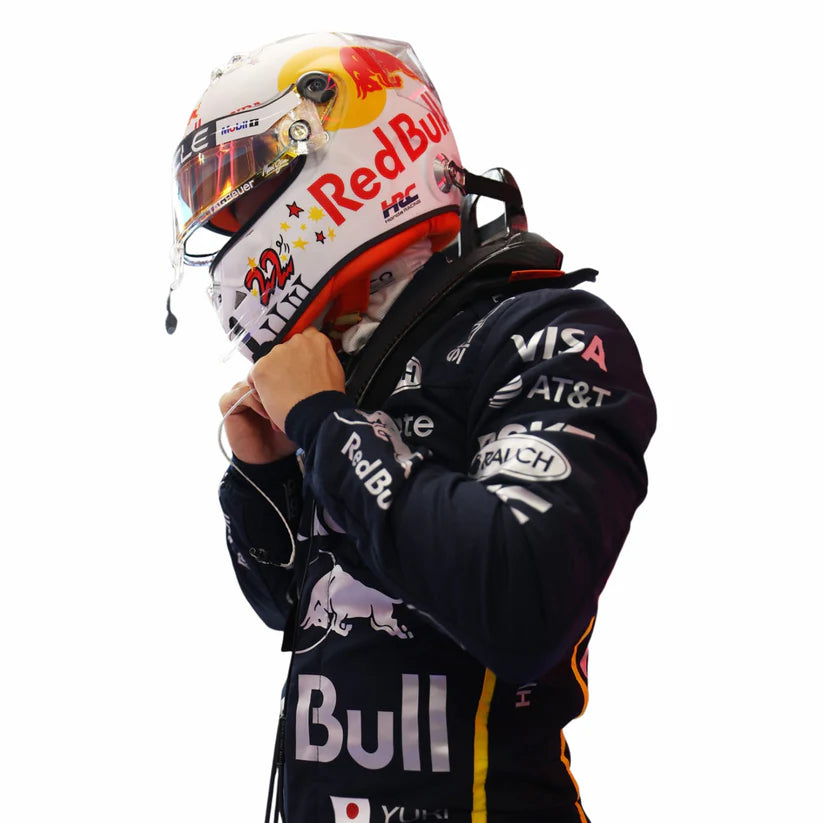 Yuki Tsunoda Red Bull 2025 Las Vegas GP F1 Racing Suit and helmet with various sponsor logos on a white background