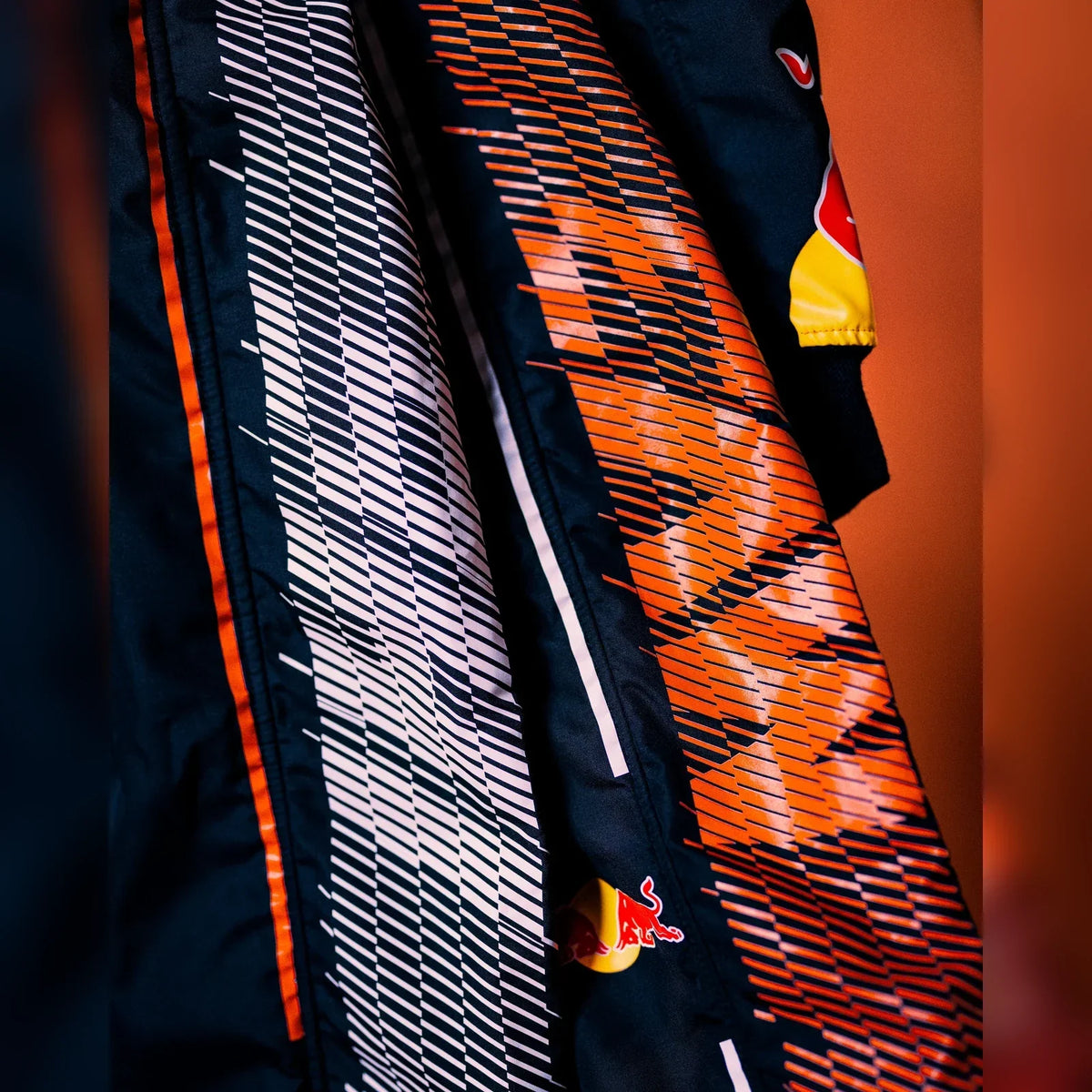 2026 Zandvoort race suit orange and white fabric detail by Reaxion Racegear