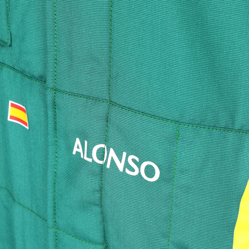  Alonso name and Spanish flag detail on the green 2026 Aston Martin F1 race suit – Reaxion Racegear.