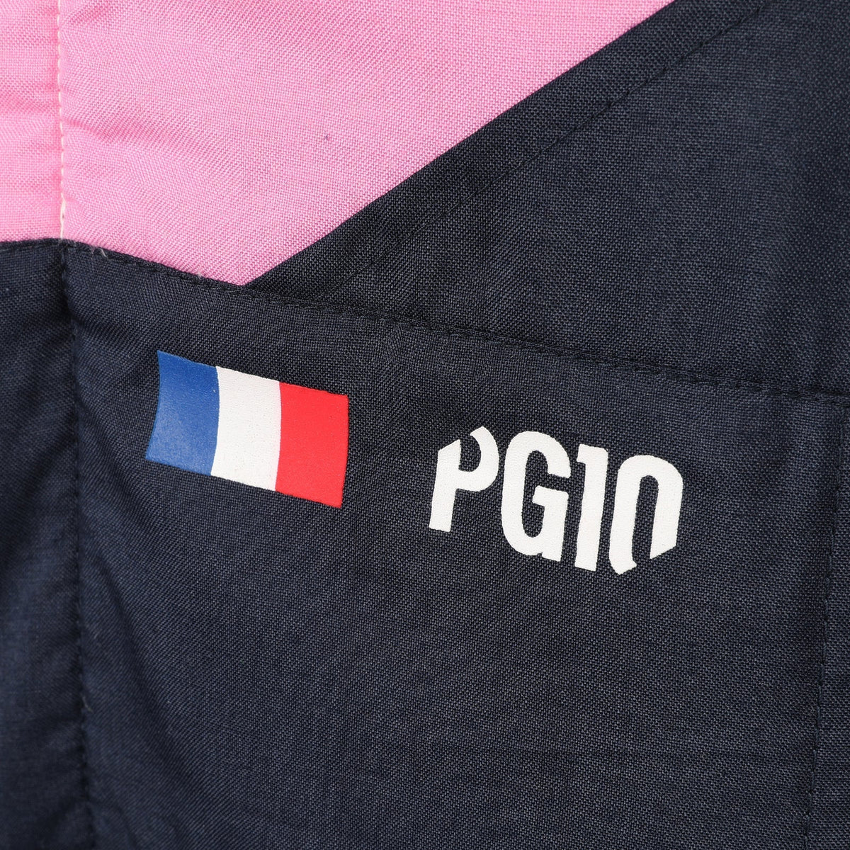 Pierre Gasly PG10 and French flag detail on the 2026 Alpine F1 race suit – Reaxion Racegear.